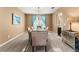 Formal dining room featuring a chandelier and large windows at 10825 Bernini Dr, Las Vegas, NV 89141