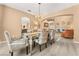Bright dining room with a chandelier and seating for six at 10825 Bernini Dr, Las Vegas, NV 89141
