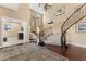 Grand entryway with curved staircase and hardwood floors at 10825 Bernini Dr, Las Vegas, NV 89141