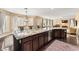 Open kitchen boasts granite island, stainless steel appliances, and hardwood floors at 10825 Bernini Dr, Las Vegas, NV 89141
