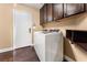Well-appointed laundry room with washer, dryer, and ample cabinetry at 10825 Bernini Dr, Las Vegas, NV 89141