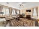 Spacious living room featuring hardwood floors, fireplace, and large windows at 10825 Bernini Dr, Las Vegas, NV 89141