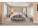 Bright and airy main bedroom with a comfortable bed and bench at 10825 Bernini Dr, Las Vegas, NV 89141