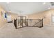 Spacious upstairs hallway with carpeting and wrought iron railing at 10825 Bernini Dr, Las Vegas, NV 89141