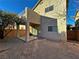 Home's backyard with covered patio and gravel at 11660 Fiorello Ct, Las Vegas, NV 89183