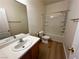 Clean bathroom with a tub/shower combo and wood-look floors at 11660 Fiorello Ct, Las Vegas, NV 89183