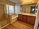 Bathroom with double vanity, large mirror, and walk-in shower at 11660 Fiorello Ct, Las Vegas, NV 89183