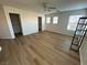 Bright bedroom with ceiling fan, wood-look floors, and large windows at 11660 Fiorello Ct, Las Vegas, NV 89183
