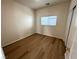 Well-lit bedroom with wood-look floors and window blinds at 11660 Fiorello Ct, Las Vegas, NV 89183