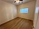 Simple bedroom with wood-look floors and a ceiling fan at 11660 Fiorello Ct, Las Vegas, NV 89183