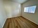 Spacious bedroom with wood-look floors and a window at 11660 Fiorello Ct, Las Vegas, NV 89183
