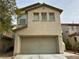 Two-story house with attached garage and neutral color scheme at 11660 Fiorello Ct, Las Vegas, NV 89183