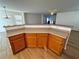 Kitchen island with wood cabinets and neutral countertops at 11660 Fiorello Ct, Las Vegas, NV 89183
