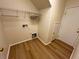 Laundry room with built-in shelving and vinyl flooring at 11660 Fiorello Ct, Las Vegas, NV 89183