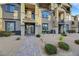 Townhome with brick walkway and landscaping leading to the front door at 1180 Solano Hills Ct, Henderson, NV 89002