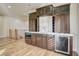 Elegant wet bar with dark wood cabinetry, wine storage, and a built-in microwave at 12237 Olivetta Ct, Las Vegas, NV 89138