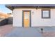 Front exterior view of the house with a yellow door and gray accents at 1720 Hassett Ave, Las Vegas, NV 89104