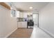 Modern kitchen with white cabinets, stainless steel appliances, and vinyl flooring at 1720 Hassett Ave, Las Vegas, NV 89104