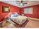 Bright bedroom with a comfy bed, red walls, and hardwood floors at 1760 Westwind Rd, Las Vegas, NV 89146