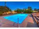 Inviting pool with surrounding patio and lighting at 1760 Westwind Rd, Las Vegas, NV 89146