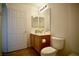Bathroom with a large mirror and a vanity with wooden cabinets and a toilet at 23 E Agate Ave # 506, Las Vegas, NV 89123