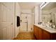 Bathroom featuring a glass enclosed shower, double sinks and storage at 23 E Agate Ave # 506, Las Vegas, NV 89123