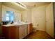 Bathroom with a double vanity sink, large mirror and tiled floors at 23 E Agate Ave # 506, Las Vegas, NV 89123