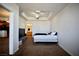 Bedroom features a tray ceiling with fan, carpet floors, and access to the ensuite bathroom at 23 E Agate Ave # 506, Las Vegas, NV 89123
