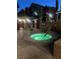 Cozy, lit outdoor hot tub area with lounge chairs and privacy wall at nighttime at 23 E Agate Ave # 506, Las Vegas, NV 89123