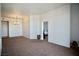 Living area with neutral walls, carpet, and modern lighting fixture at 23 E Agate Ave # 506, Las Vegas, NV 89123