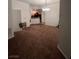 Spacious living room with brown carpet and kitchen view at 23 E Agate Ave # 506, Las Vegas, NV 89123