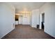 Bright living room featuring neutral walls and flooring with views into the kitchen area at 23 E Agate Ave # 506, Las Vegas, NV 89123