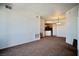 Spacious carpeted living room leading into the kitchen with natural light at 23 E Agate Ave # 506, Las Vegas, NV 89123