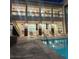 Inviting outdoor pool and lounge area with a view of the building's gym facilities at nighttime at 23 E Agate Ave # 506, Las Vegas, NV 89123