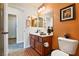 Bathroom features a double vanity and an orange accent wall at 2755 Sunken Ship St, Laughlin, NV 89029