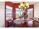 Round dining table with seating for four and red walls at 2755 Sunken Ship St, Laughlin, NV 89029