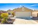 Tan house with a two-car garage and desert landscaping at 2755 Sunken Ship St, Laughlin, NV 89029