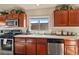 Kitchen with wood cabinets, stainless steel appliances, and tile floors at 2755 Sunken Ship St, Laughlin, NV 89029