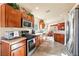 Kitchen with wood cabinets, stainless steel appliances, and tile floors at 2755 Sunken Ship St, Laughlin, NV 89029