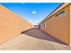 Side yard with gravel and block walls at 2755 Sunken Ship St, Laughlin, NV 89029