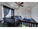 Cozy bedroom with two beds and ceiling fan at 2764 Heritage Ct, Las Vegas, NV 89121