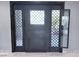 Impressive dark gray wrought iron front door with a geometric glass design at 2900 Augusta Dr, Las Vegas, NV 89109