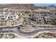 Aerial view of houses, palm trees, and a circular road at 30 Hilltop Crest St, Henderson, NV 89011