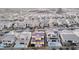 An aerial view shows the home's backyard pool and neighborhood in a community with mountain views at 30 Hilltop Crest St, Henderson, NV 89011