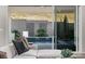 View from the living room to the backyard featuring water feature and desert landscape at 30 Hilltop Crest St, Henderson, NV 89011