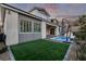 Landscaped backyard with artificial turf and a spa at 30 Hilltop Crest St, Henderson, NV 89011