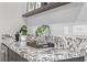 Close-up of a bar featuring granite countertops, stylish decor, and dark wood cabinetry at 30 Hilltop Crest St, Henderson, NV 89011