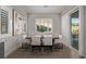 Bright dining room features plantation shutters, a modern light fixture, and access to the backyard at 30 Hilltop Crest St, Henderson, NV 89011