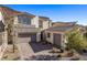 Inviting two-story home featuring a two-car garage, landscaped yard, and a brick driveway for added curb appeal at 30 Hilltop Crest St, Henderson, NV 89011