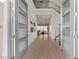 Open foyer with wood-look tile, a metal staircase and art at 30 Hilltop Crest St, Henderson, NV 89011